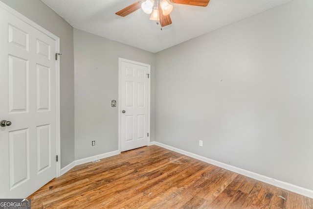 200 Wildwood, Calhoun, GA 30701 - empty room with ceiling fan, baseboards, light wood-style floors, and a textured ceiling