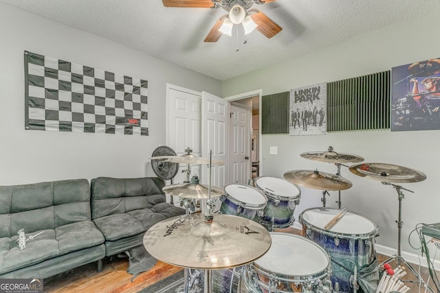 200 Wildwood, Calhoun, GA 30701 - living room with ceiling fan, a textured ceiling, wood finished floors, and baseboards