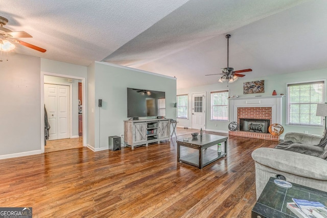 200 Wildwood, Calhoun, GA 30701 - living area featuring a ceiling fan, wood finished floors, healthy amount of natural light, vaulted ceiling, and a textured ceiling