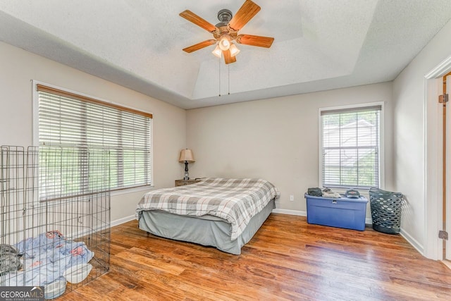 200 Wildwood, Calhoun, GA 30701 - bedroom with wood finished floors, a tray ceiling, baseboards, and a textured ceiling