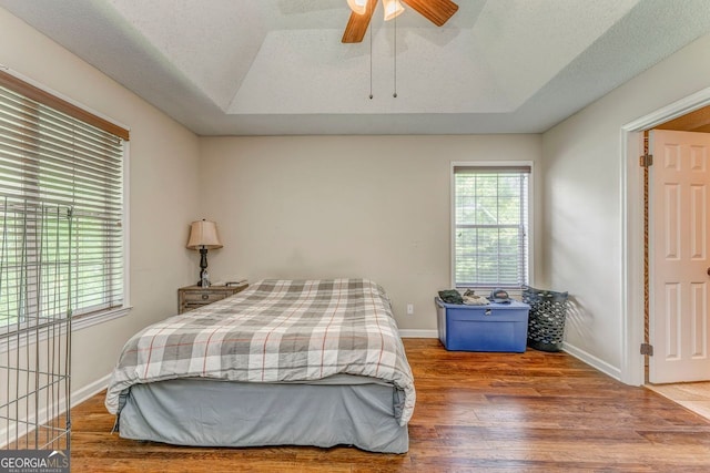 200 Wildwood, Calhoun, GA 30701 - bedroom featuring wood finished floors, baseboards, a tray ceiling, and ceiling fan