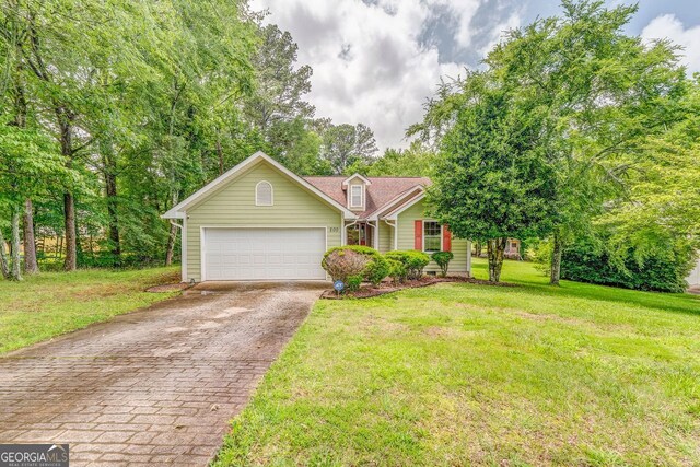 200 Wildwood, Calhoun, GA 30701 - view of front of home featuring driveway, a front lawn, and an attached garage