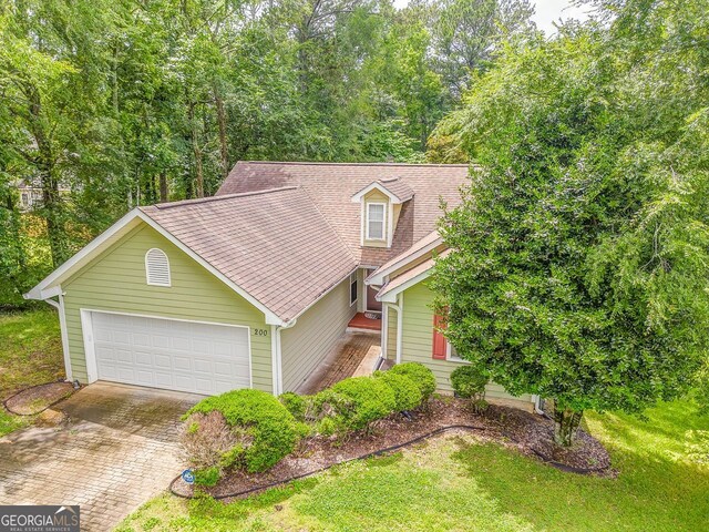 200 Wildwood, Calhoun, GA 30701 - view of front of property with roof with shingles, an attached garage, driveway, and a front yard