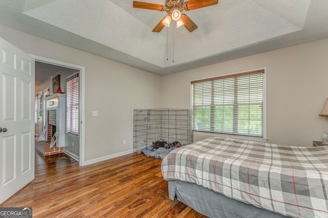 200 Wildwood, Calhoun, GA 30701 - bedroom with wood finished floors, multiple windows, baseboards, and a textured ceiling