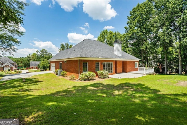 40 Costleys Bridge Dr, Oxford, GA 30054 - back of property with driveway, a yard, brick siding, a chimney, and a patio area