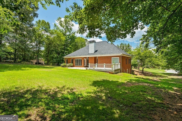40 Costleys Bridge Dr, Oxford, GA 30054 - rear view of property featuring brick siding, a deck, a lawn, and a chimney