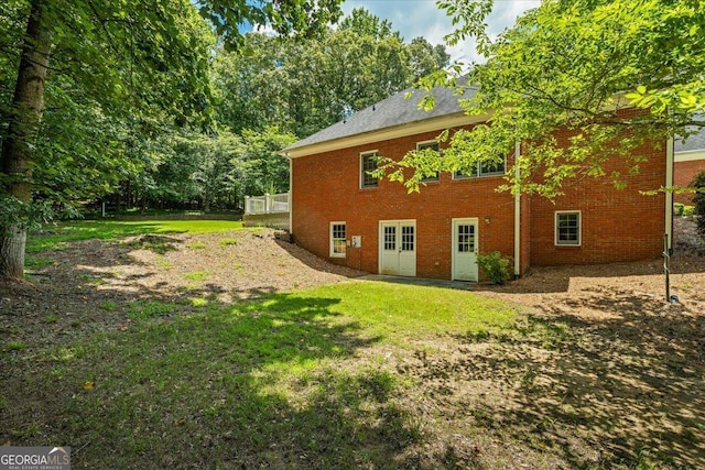 40 Costleys Bridge Dr, Oxford, GA 30054 - rear view of house with brick siding, a yard, and a wooden deck