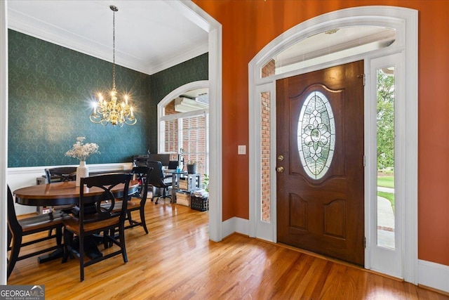 40 Costleys Bridge Dr, Oxford, GA 30054 - entryway with wallpapered walls, a chandelier, ornamental molding, wood finished floors, and wainscoting