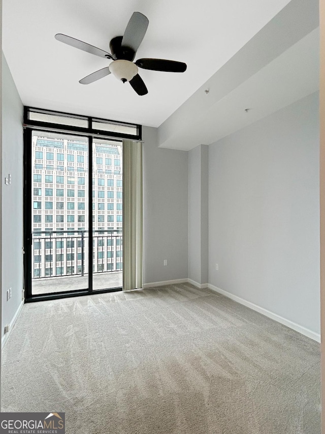 3040 Peachtree Rd Unit 1501, Atlanta, GA 30305 - empty room with expansive windows, a ceiling fan, carpet, and baseboards