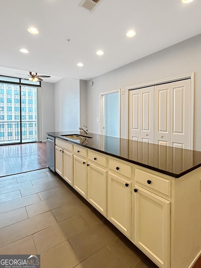 3040 Peachtree Rd Unit 1501, Atlanta, GA 30305 - kitchen with a sink, stainless steel dishwasher, dark countertops, recessed lighting, and ceiling fan