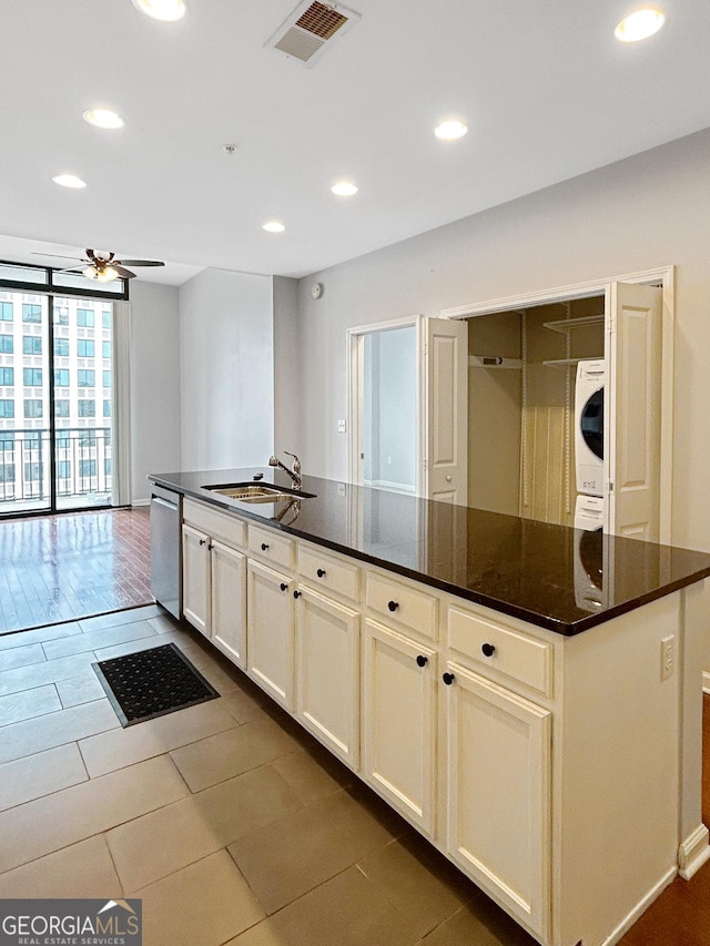 3040 Peachtree Rd Unit 1501, Atlanta, GA 30305 - kitchen featuring estacked washer and dryer, dishwasher, a ceiling fan, recessed lighting, and a sink