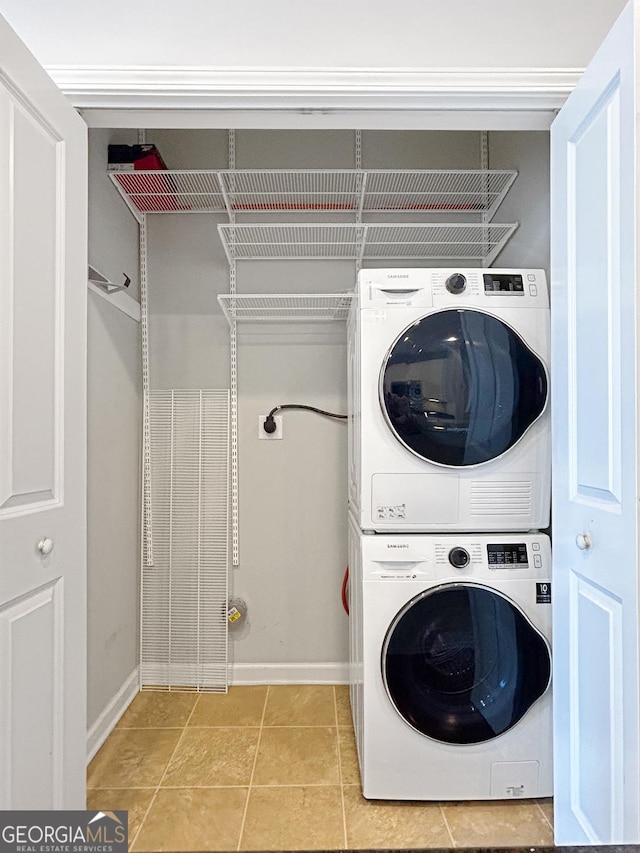 3040 Peachtree Rd Unit 1501, Atlanta, GA 30305 - laundry room with estacked washer and dryer, baseboards, and light tile patterned flooring