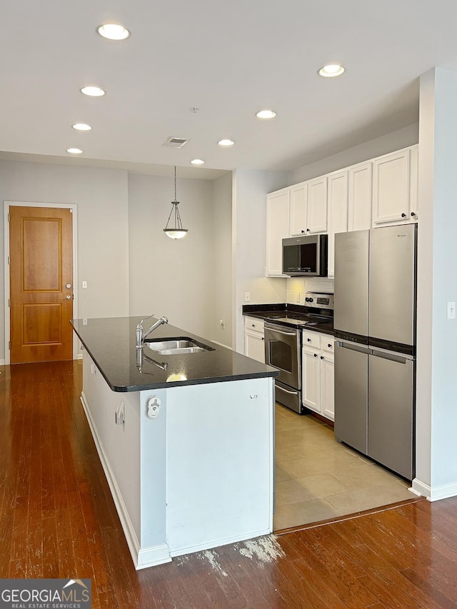 3040 Peachtree Rd Unit 1501, Atlanta, GA 30305 - kitchen featuring stainless steel appliances, a sink, dark countertops, dark wood-style floors, and recessed lighting