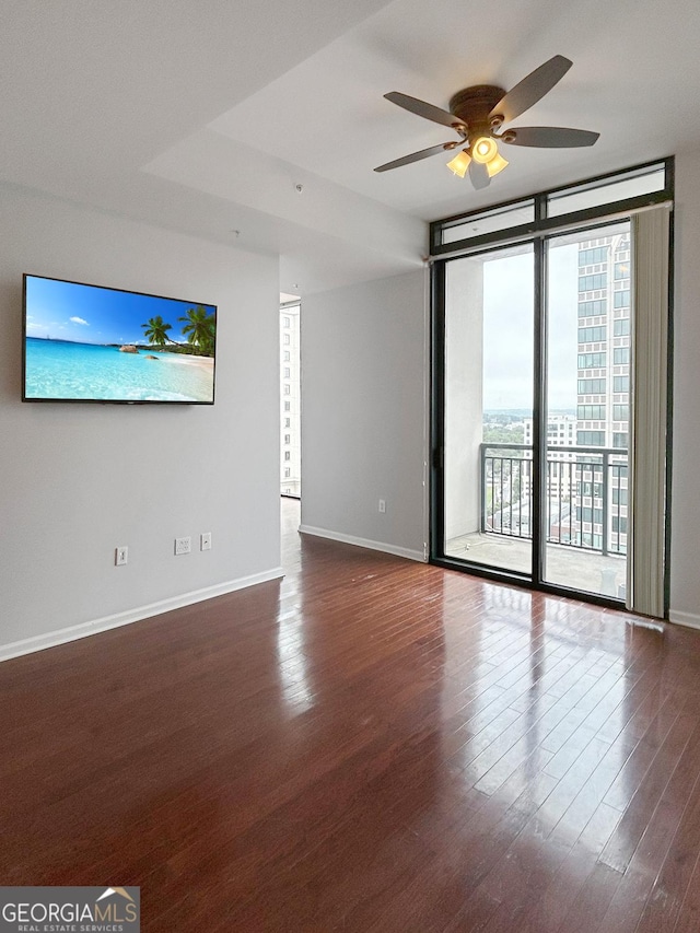3040 Peachtree Rd Unit 1501, Atlanta, GA 30305 - unfurnished room with floor to ceiling windows, dark wood-type flooring, a ceiling fan, and baseboards