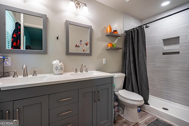 101 Crestwood Dr, Lagrange, GA 30241 - full bath featuring double vanity, toilet, wood finished floors, and tiled shower