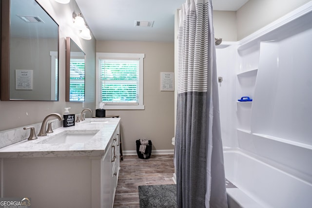 101 Crestwood Dr, Lagrange, GA 30241 - bathroom featuring double vanity, wood finished floors, shower / bathtub combination with curtain, baseboards, and toilet