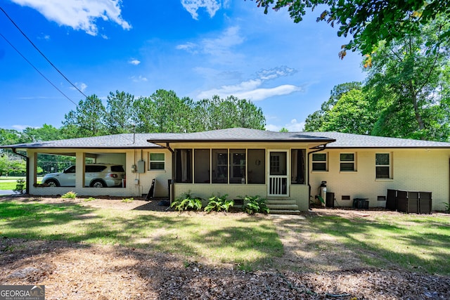 101 Crestwood Dr, Lagrange, GA 30241 - back of house featuring brick siding, a sunroom, an attached carport, a yard, and entry steps