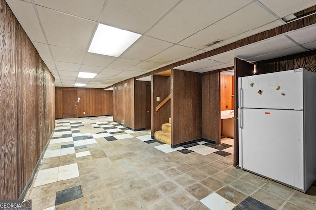 900 Fleetwood Cir SW, Atlanta, GA 30311 - finished basement featuring freestanding refrigerator, wood walls, a drop ceiling, and stairway