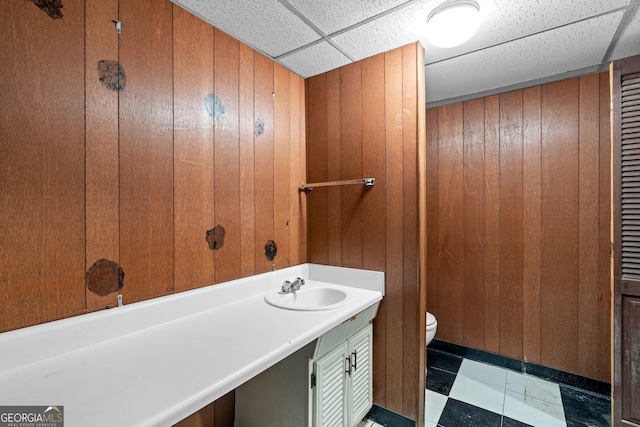 900 Fleetwood Cir SW, Atlanta, GA 30311 - bathroom featuring toilet, wooden walls, a paneled ceiling, and vanity