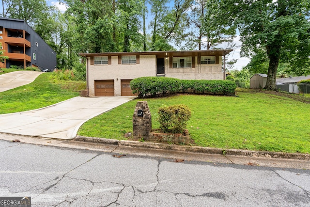 900 Fleetwood Cir SW, Atlanta, GA 30311 - view of front facade featuring driveway, a front lawn, a garage, and brick siding