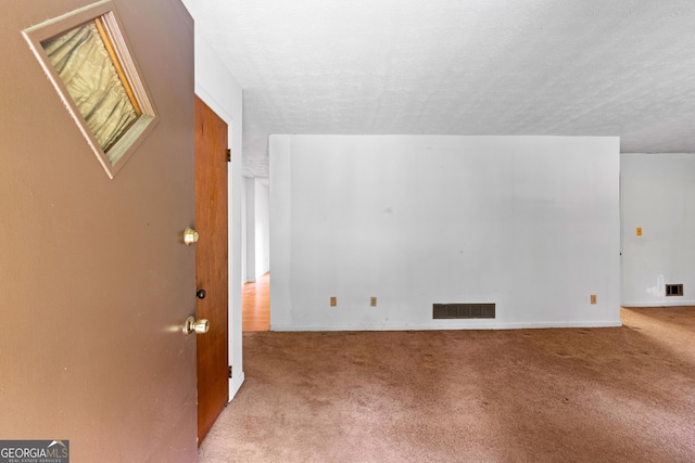 900 Fleetwood Cir SW, Atlanta, GA 30311 - unfurnished living room with carpet floors, baseboards, and a textured ceiling