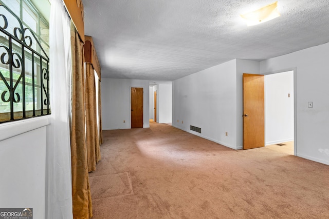 900 Fleetwood Cir SW, Atlanta, GA 30311 - empty room with carpet floors, a textured ceiling, and baseboards