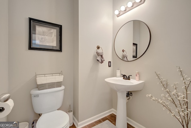 17 Roxbury Ln, Newnan, GA 30265 - half bathroom with toilet, baseboards, and wood finished floors