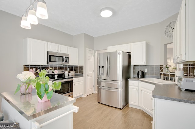 17 Roxbury Ln, Newnan, GA 30265 - kitchen featuring stainless steel appliances, a sink, white cabinetry, and backsplash