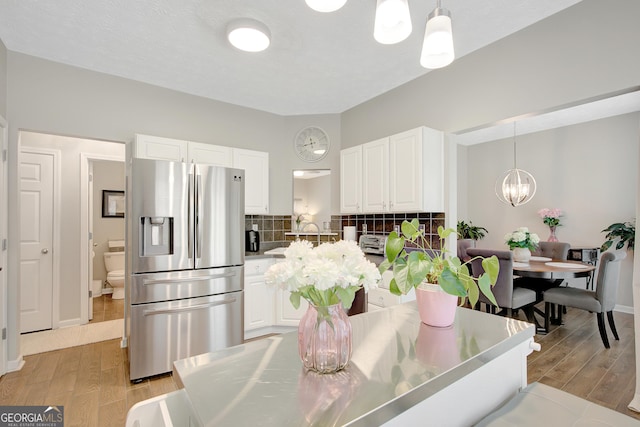 17 Roxbury Ln, Newnan, GA 30265 - dining space with a chandelier, light wood finished floors, and baseboards