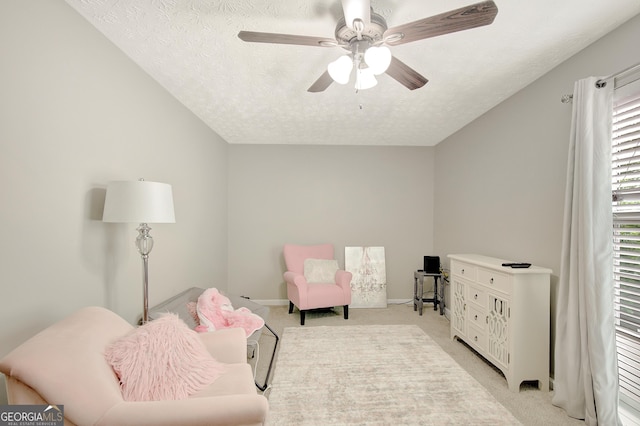 17 Roxbury Ln, Newnan, GA 30265 - sitting room featuring light colored carpet, a textured ceiling, a ceiling fan, and baseboards