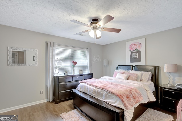 17 Roxbury Ln, Newnan, GA 30265 - bedroom with light wood-style floors, baseboards, a textured ceiling, and a ceiling fan