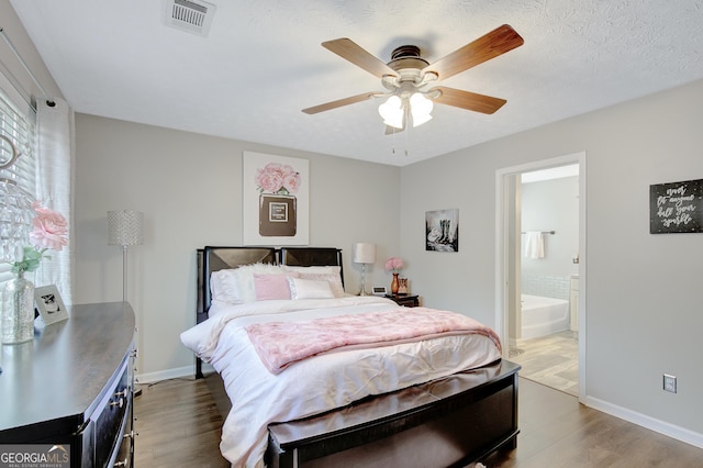 17 Roxbury Ln, Newnan, GA 30265 - bedroom featuring wood finished floors, baseboards, ensuite bath, and ceiling fan