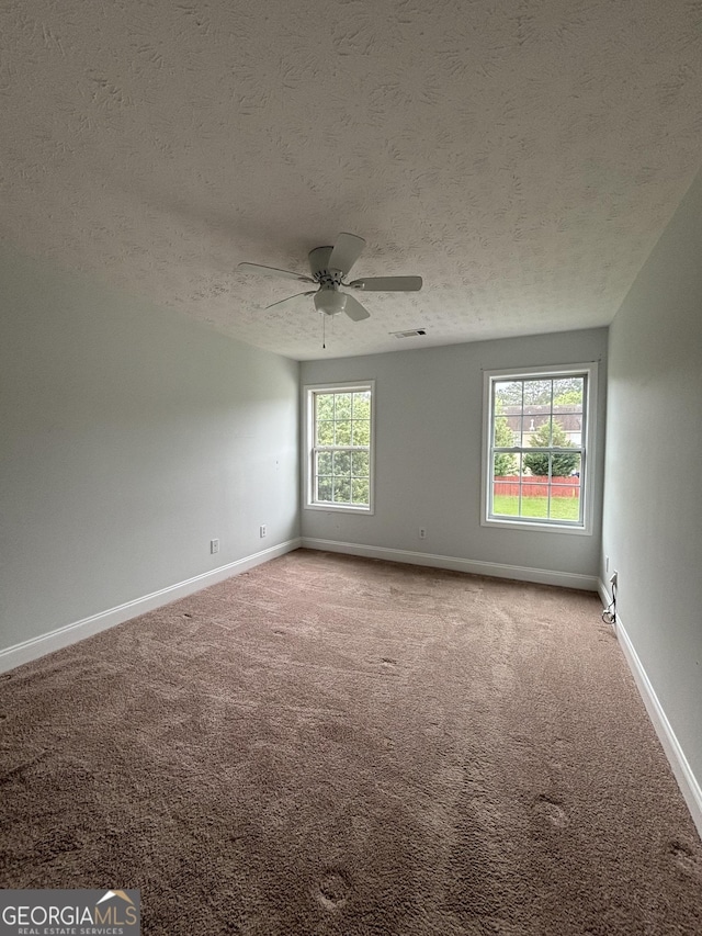 4069 Savannah Ridge Ct, Loganville, GA 30052 - empty room featuring a textured ceiling, carpet floors, baseboards, and ceiling fan