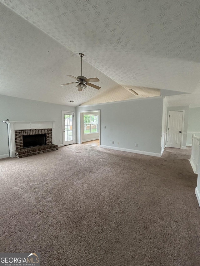 4069 Savannah Ridge Ct, Loganville, GA 30052 - unfurnished living room with a textured ceiling, carpet, a fireplace, baseboards, and ceiling fan