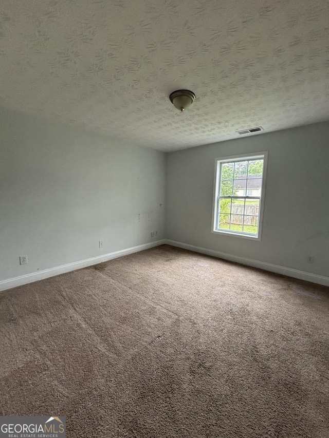 4069 Savannah Ridge Ct, Loganville, GA 30052 - carpeted spare room featuring baseboards and a textured ceiling