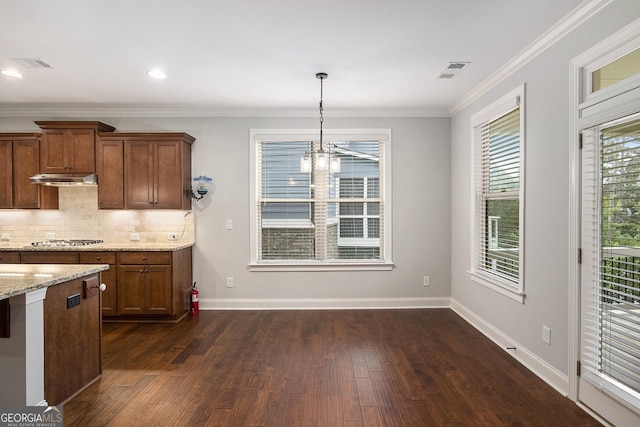 7139 Lake Edge Dr, Flowery Branch, GA 30542 - kitchen featuring dark wood-style floors, under cabinet range hood, brown cabinets, a chandelier, and light stone counters