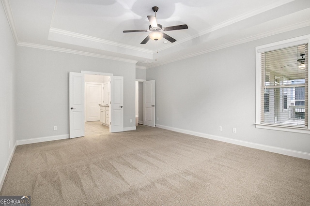 7139 Lake Edge Dr, Flowery Branch, GA 30542 - unfurnished bedroom featuring a raised ceiling, light colored carpet, crown molding, connected bathroom, and a ceiling fan