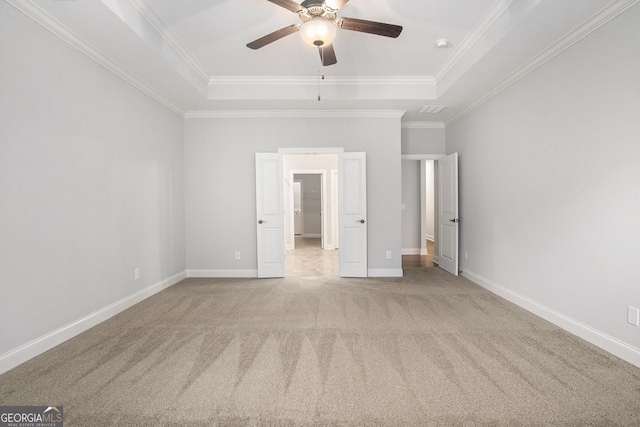 7139 Lake Edge Dr, Flowery Branch, GA 30542 - unfurnished bedroom featuring a tray ceiling, carpet, crown molding, and a ceiling fan