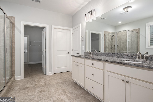 7139 Lake Edge Dr, Flowery Branch, GA 30542 - bathroom featuring a spacious closet, a stall shower, and double vanity