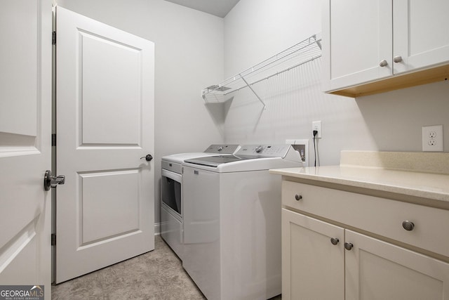 7139 Lake Edge Dr, Flowery Branch, GA 30542 - washroom featuring washer and clothes dryer and cabinet space