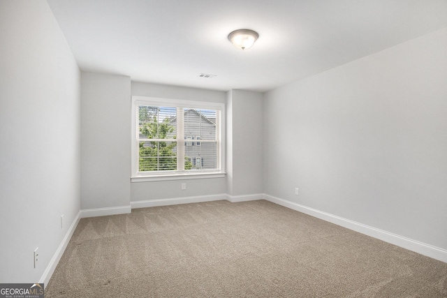 7139 Lake Edge Dr, Flowery Branch, GA 30542 - spare room with light colored carpet and baseboards