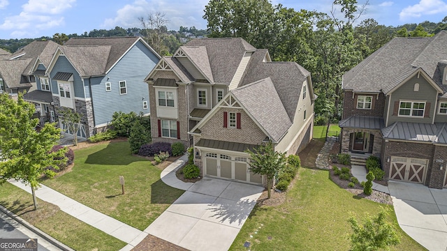 7139 Lake Edge Dr, Flowery Branch, GA 30542 - view of front facade featuring driveway, a standing seam roof, a residential view, a front yard, and roof with shingles