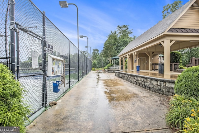 7139 Lake Edge Dr, Flowery Branch, GA 30542 - view of concrete driveway featuring a gate and street lights