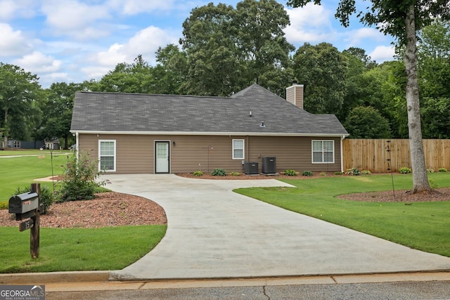 15 Livingston Way, Covington, GA 30016 - view of front facade with concrete driveway, cooling unit, a chimney, and roof with shingles