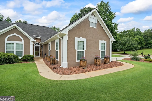 15 Livingston Way, Covington, GA 30016 - view of side of home featuring stucco siding and a lawn