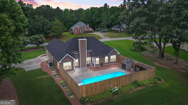 15 Livingston Way, Covington, GA 30016 - back of house at dusk with central AC unit and roof with shingles