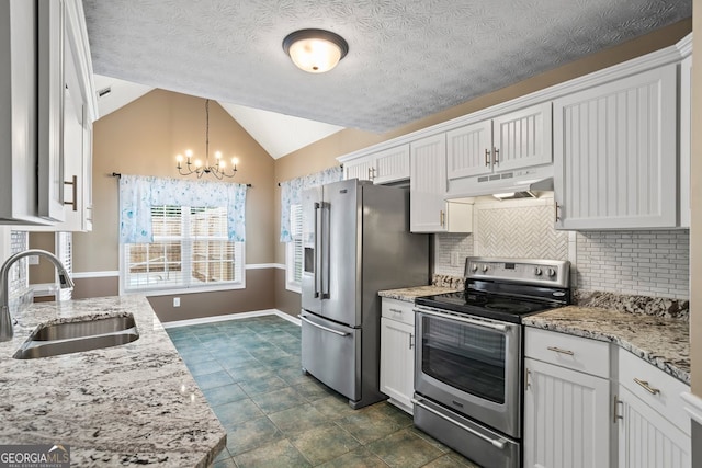 15 Livingston Way, Covington, GA 30016 - kitchen with appliances with stainless steel finishes, under cabinet range hood, a sink, a chandelier, and tasteful backsplash