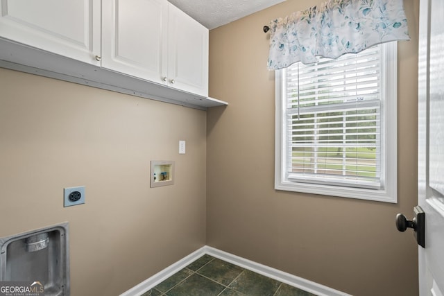 15 Livingston Way, Covington, GA 30016 - laundry area with cabinet space, hookup for an electric dryer, baseboards, washer hookup, and dark tile patterned flooring
