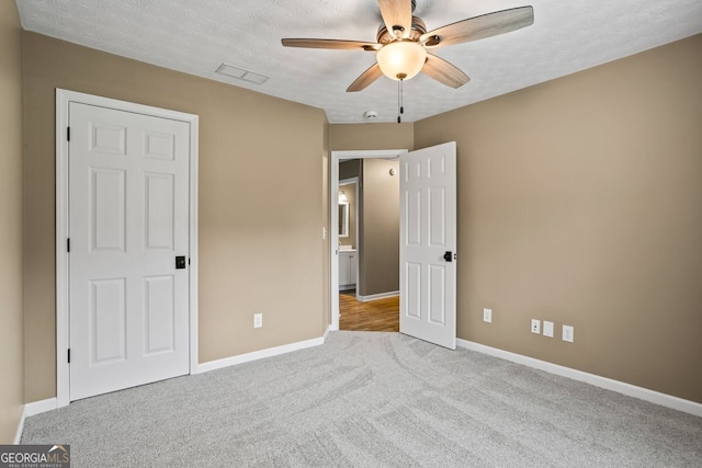15 Livingston Way, Covington, GA 30016 - unfurnished bedroom with carpet, baseboards, a textured ceiling, and ceiling fan
