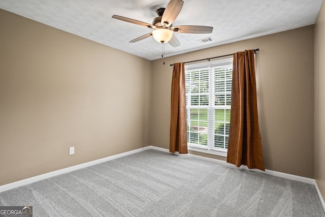 15 Livingston Way, Covington, GA 30016 - carpeted empty room with a ceiling fan, plenty of natural light, baseboards, and a textured ceiling